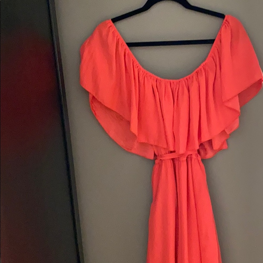 Peach colored off the shoulder dress.